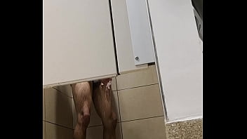Man wanking after workout in gym